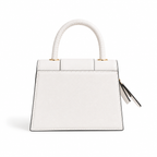 A structured white leather handbag with a curved top handle, gold-tone hardware, and a small black-and-white tassel charm, shown on a clean white background.