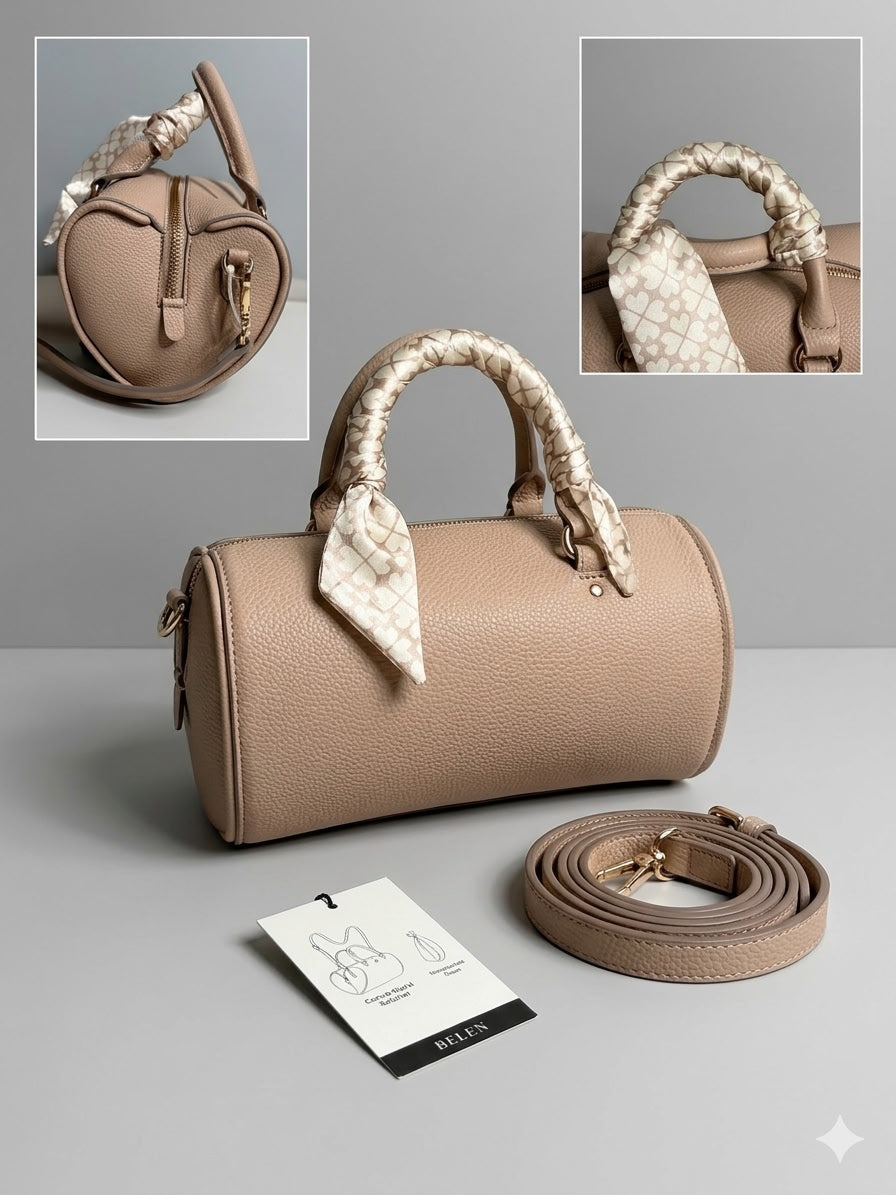 Beige handbag with decorative handles on a gray background