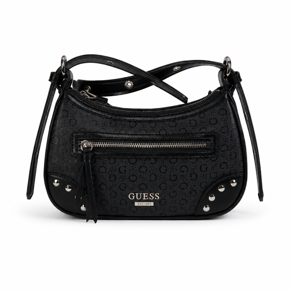 A black GUESS shoulder bag with an embossed monogram pattern, featuring a front zippered pocket, silver-tone studs, and a tassel zipper pull on a white background.