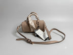 Beige handbag with a matching scarf on a gray background