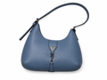 A blue pebbled leather shoulder bag with a curved top, a single strap, and a front triangular metal logo plaque, shown on a plain white background.