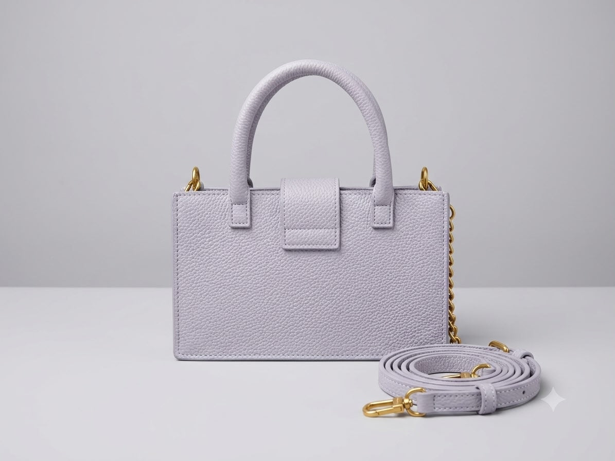 Light purple handbag with a matching strap on a light gray background