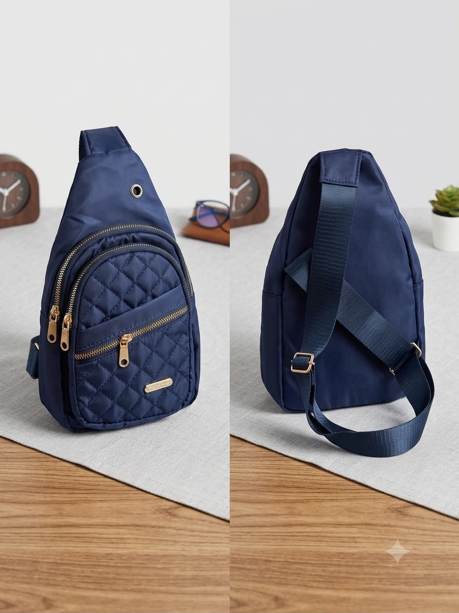 Navy blue quilted sling bag shown from front and side on a light gray surface.