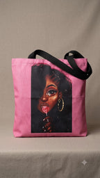 Pink tote bag with a graphic of a woman's face on a beige background